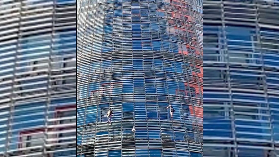 Alain Robert et son fils escaladent la tour Gloriès à Barcelone, le 1er octobre 2022.