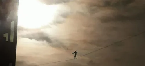 Un funambule marche à 150 mètres du sol entre deux tours de La...